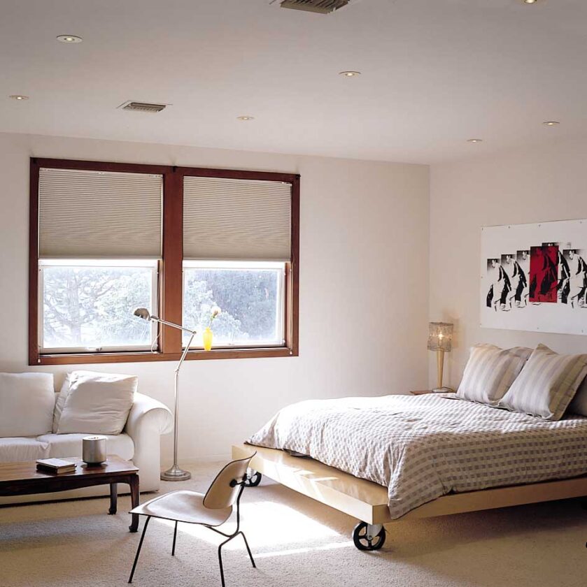 Located in a loft overlooking the main living area, above the kitchen and the guestroom, the bedroom space is small and intimate. From their bed, Jana and Claudio can watch movies projected from a ceiling projector onto a huge screen that drops in front of the southern windows.